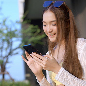 Woman controlling swim spa on a phone.