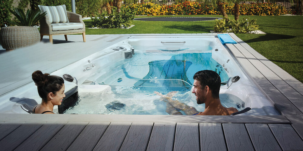 Michael and Nicole relaxing in the hot tub side of a Momentum D.